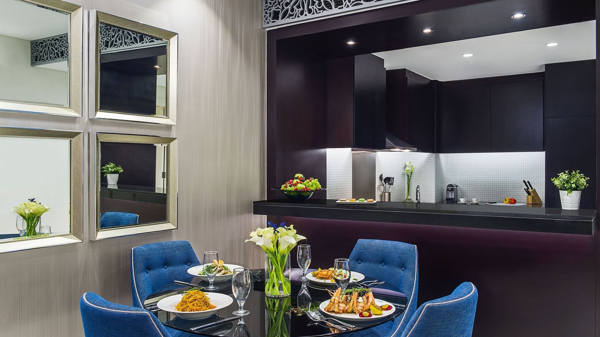 Food served on the dining table by the kitchenette in One Bedroom Suite at DAMAC Maison Distinction