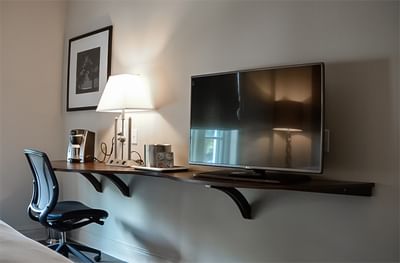 King Bed Partial View Connector, with a modern desk, and a TV at The White House Hotel, simply for work and comfort