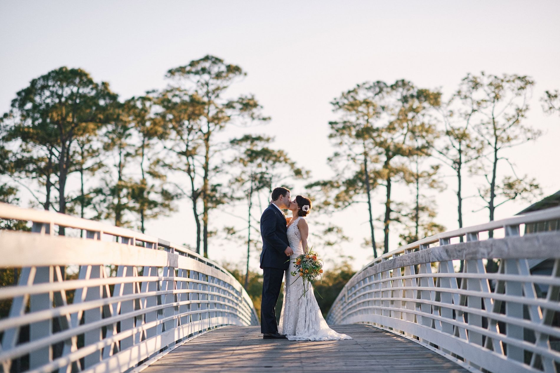 Wedding couple kissing on the Bridge at WaterColor Inn