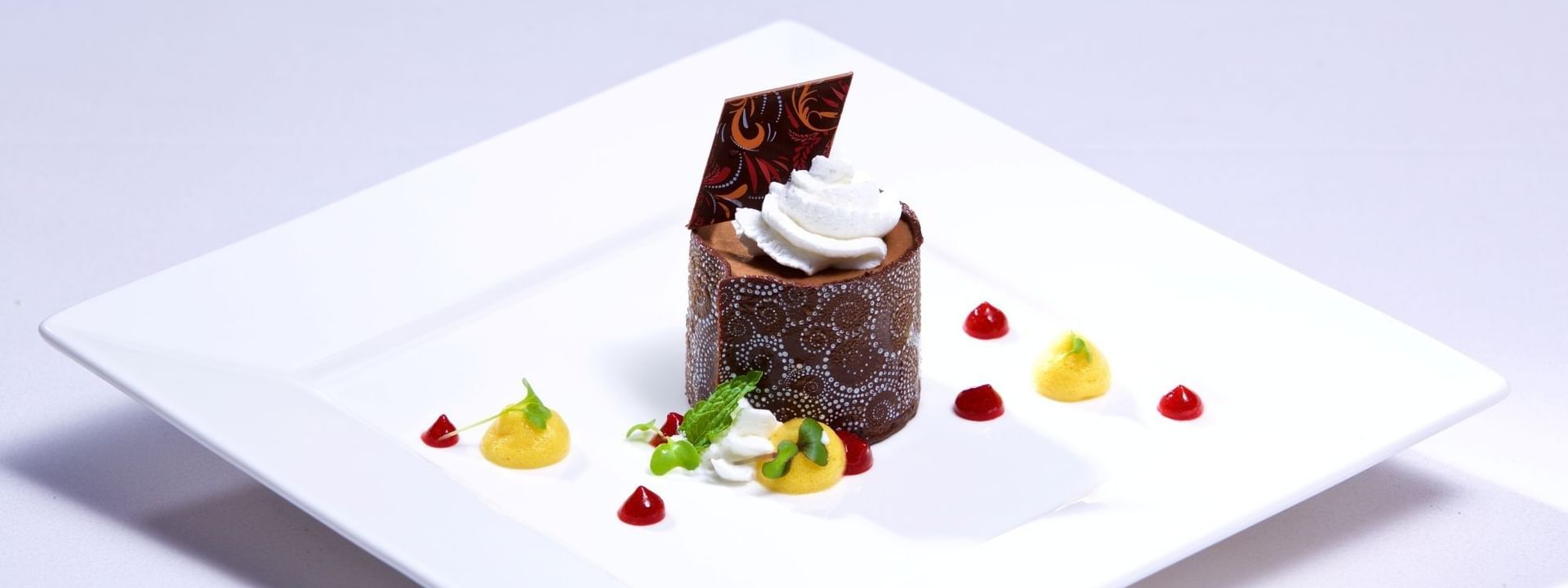 Chocolate dessert with mango coulis under whipped cream in Abbiocco at Warwick Paradise Island Bahamas