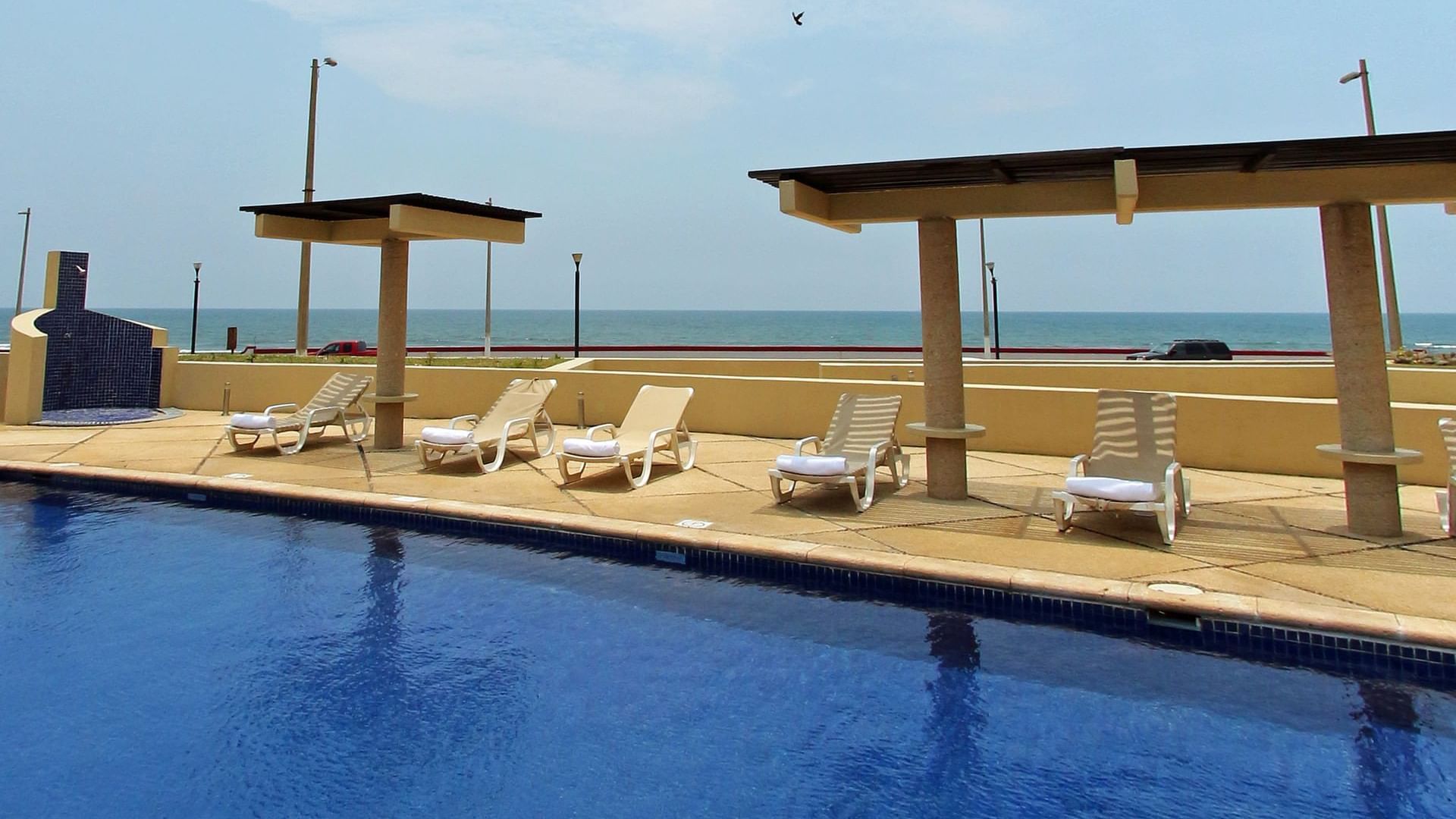 Pool area with sunbeds at Fiesta Inn Coatzacoalcos
