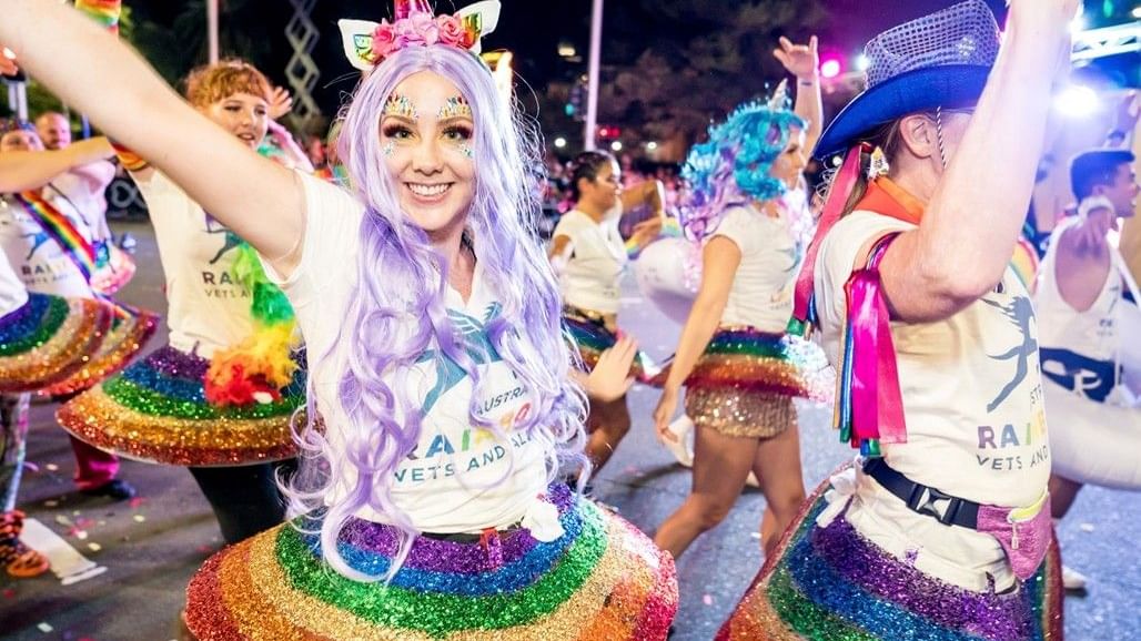 Participants in colorful costumes at the Sydney Mardi Gras 2026.