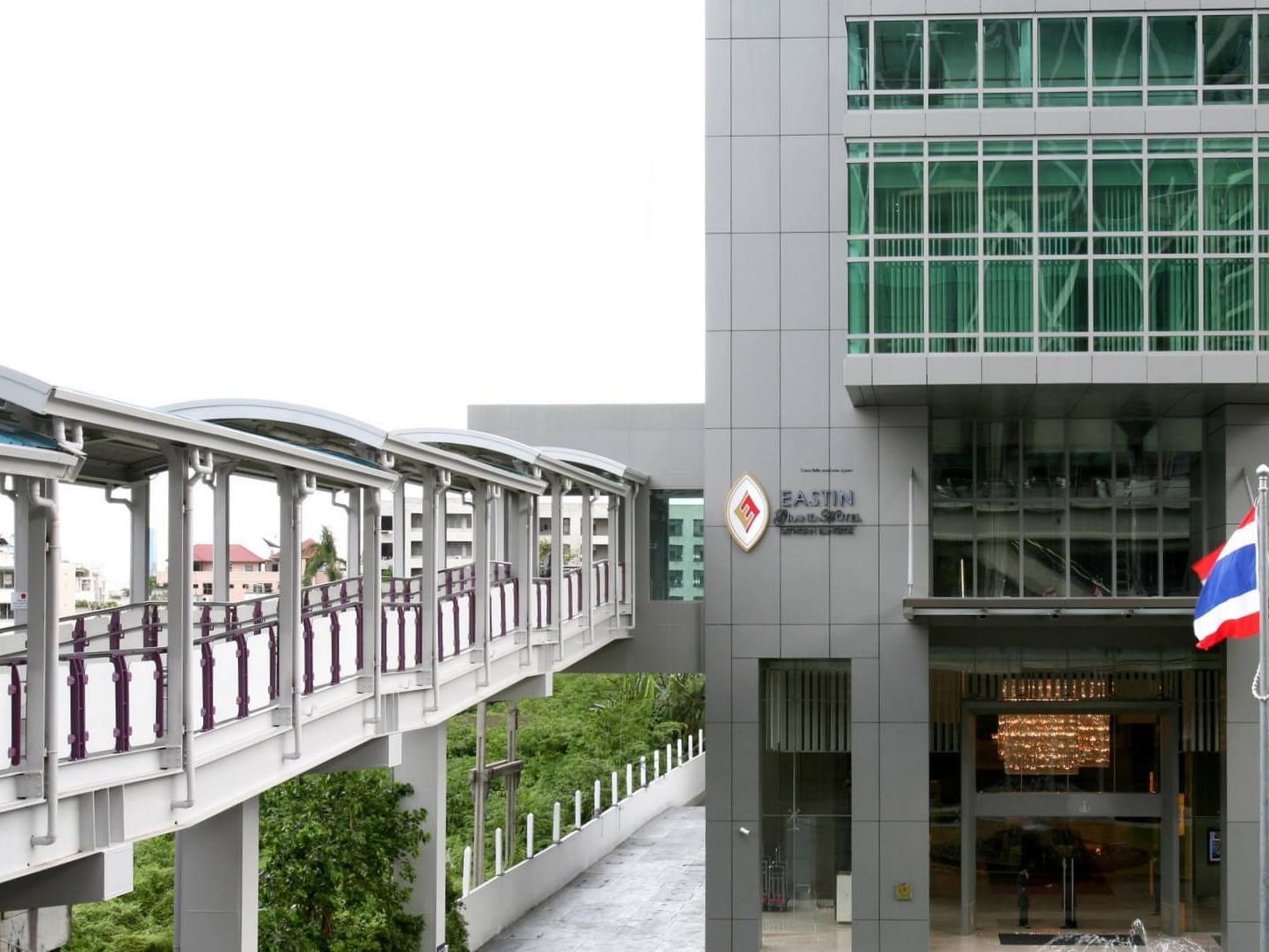 Exterior view of Eastin Grand Hotel Sathorn Bangkok by a pedestrian bridge