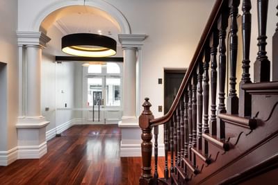 Wooden floors & stairway in the hotel lobby at Melbourne Hotel Perth