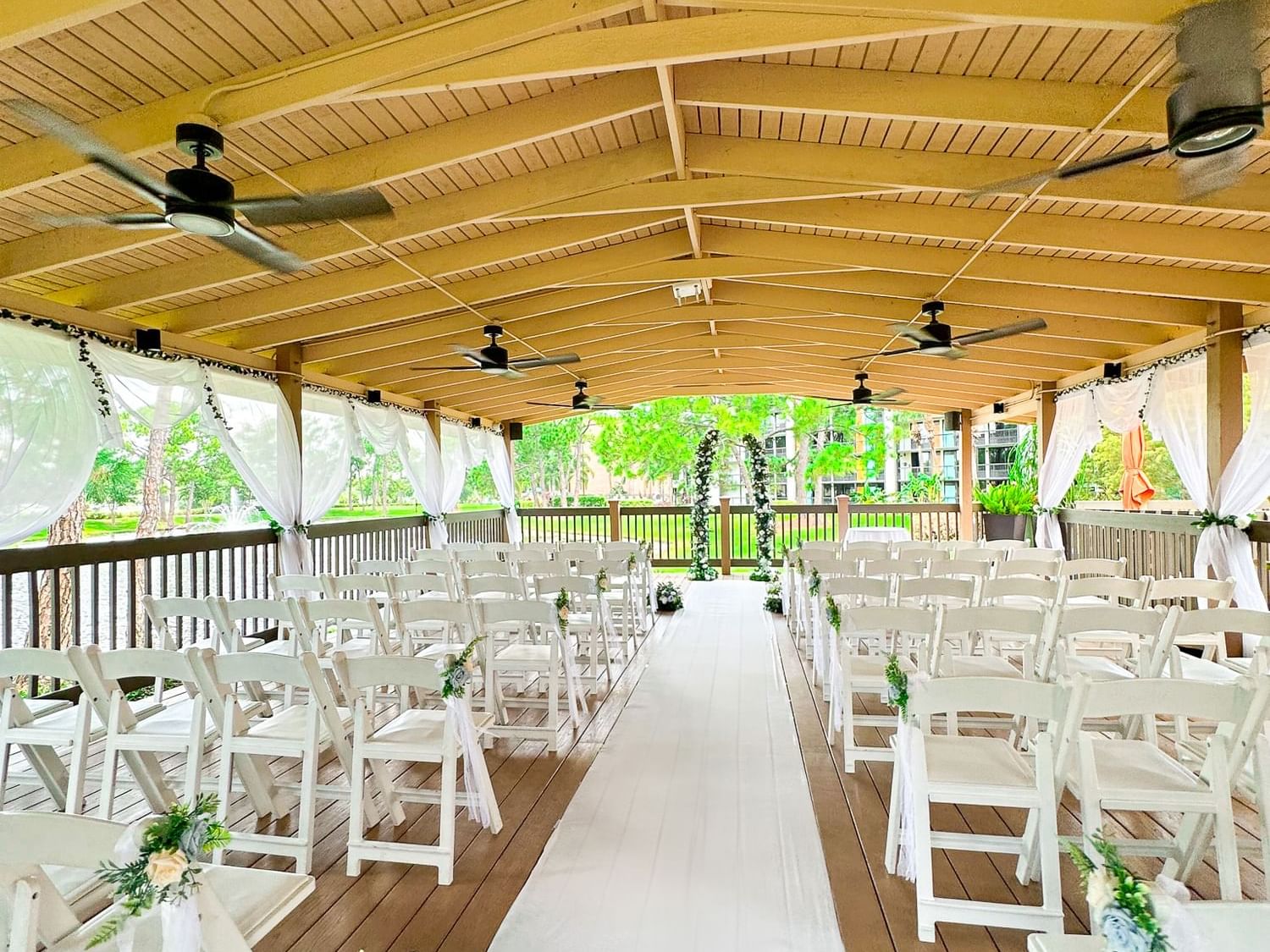 Lake pavilion wedding set up looking down the aisle