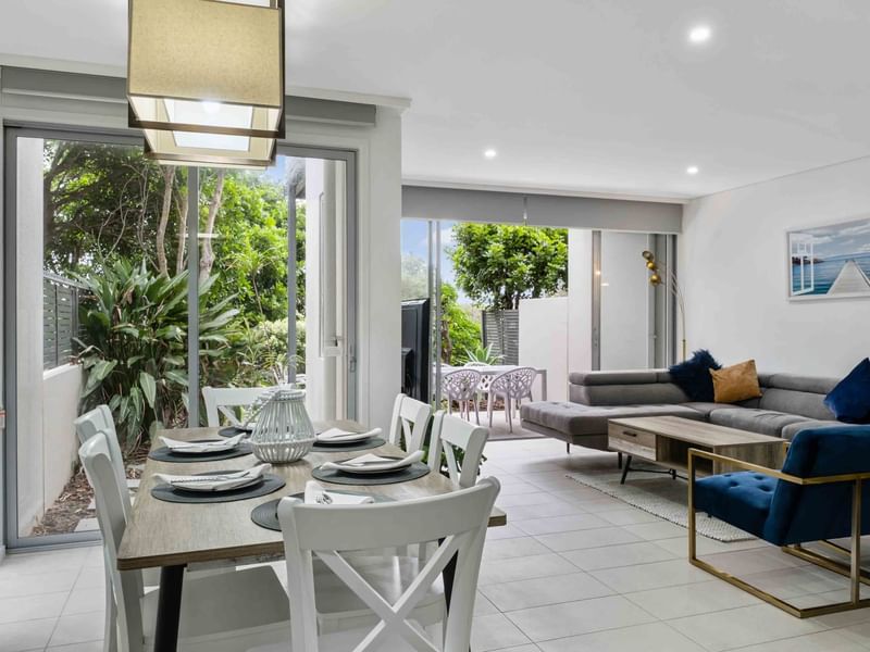 Dining table & lounge area in Deluxe Three-Bedroom Villa with a garden view at Pullman Magenta Shores