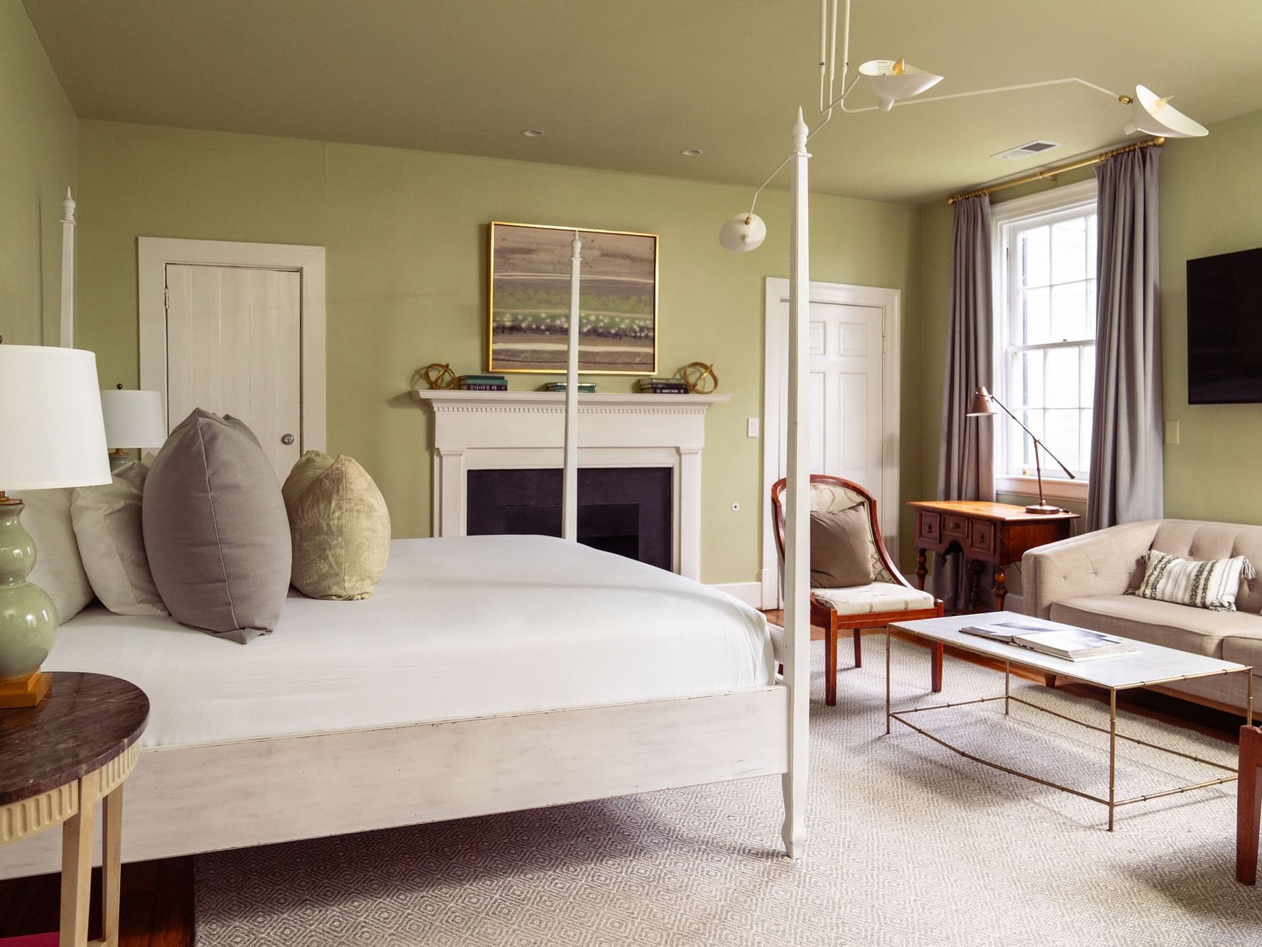 Cozy Martha Jefferson room with fireplace, large bed, and sofa at The Clifton in Charlottesville.