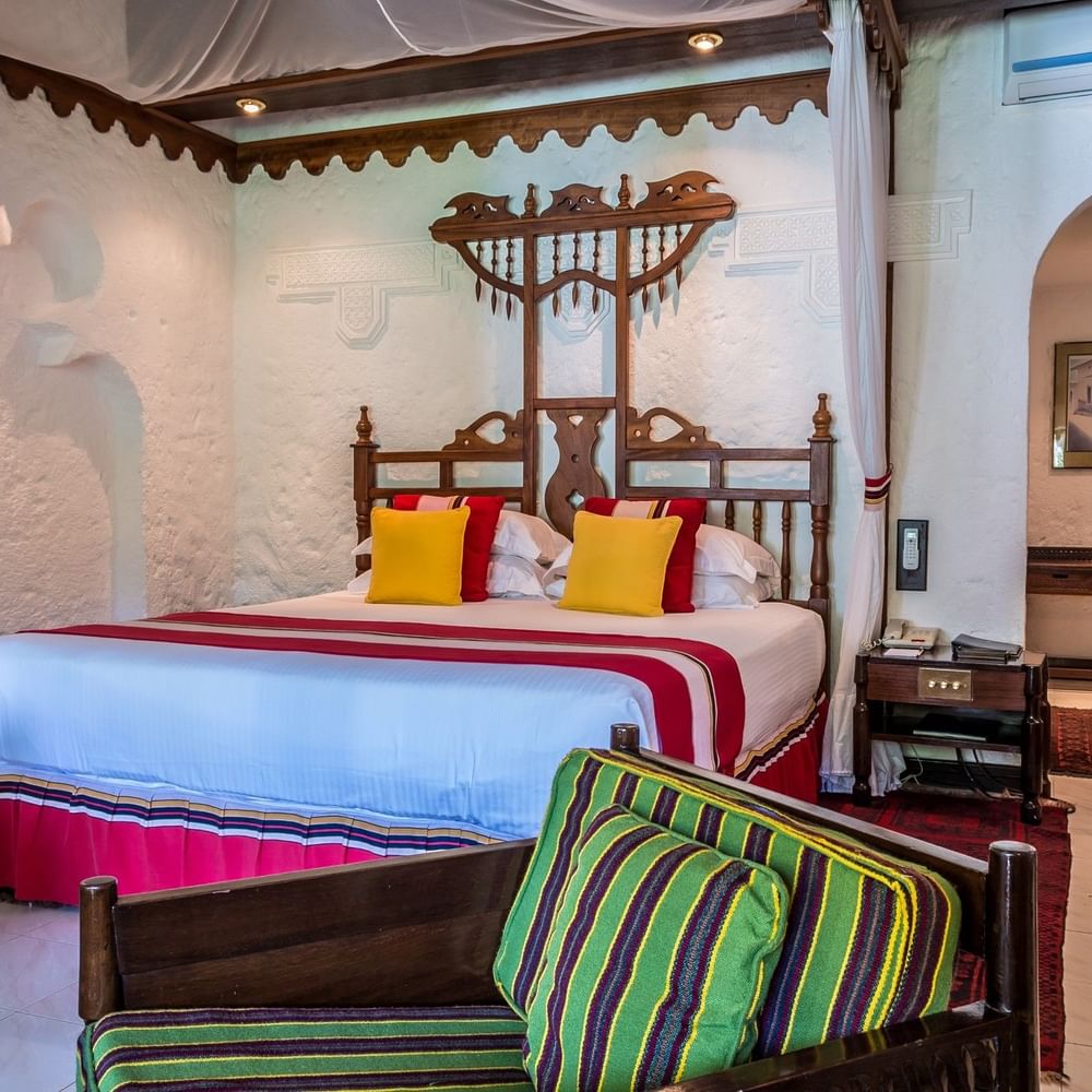 Elegant Garden Suite bedroom at Serena Beach Resort & Spa in Mombasa.