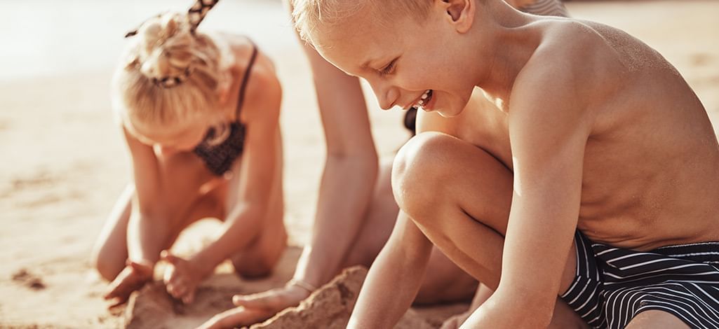 boy and girl playing at the beach