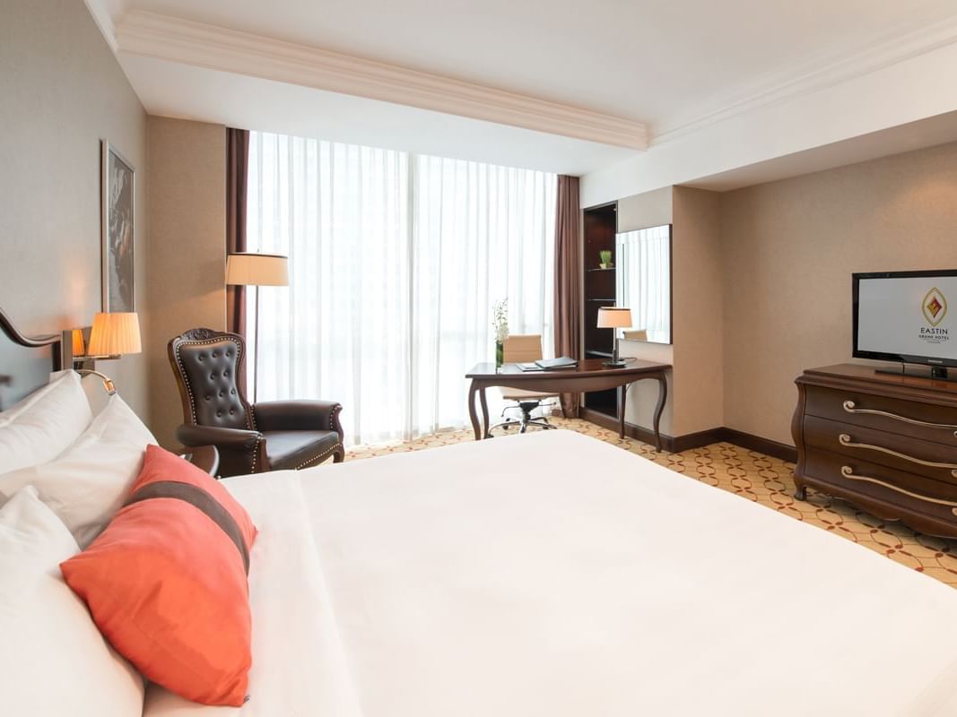 White comfy bed in Deluxe Room at Eastin Hotels