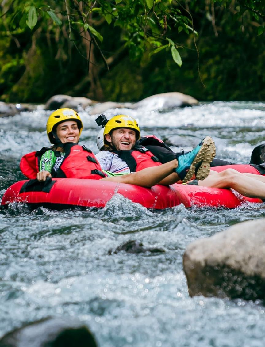 A couple rafting on the river near Hideaway Rio Celeste