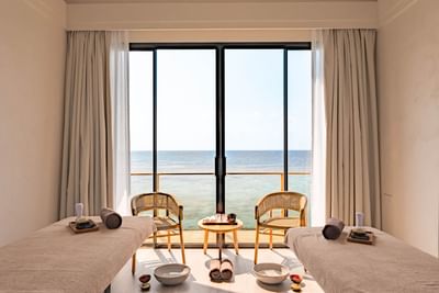 Serene Kandu Spa room at Ananea Madivaru Maldives, with massage tables, ocean views, natural light, and wellness items