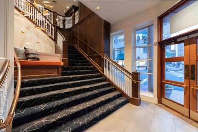 Lobby with a staircase featuring black marble steps and a wooden banister at Portland Harbor Hotel