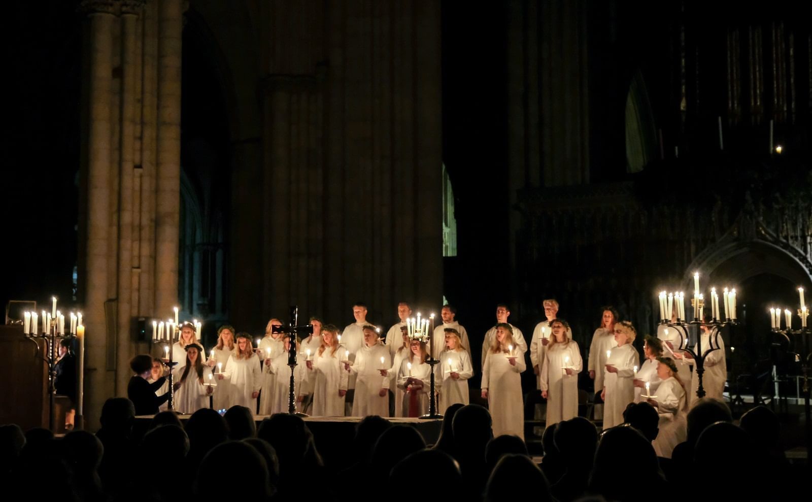 Worshipers with candles during Vigil Mass near The Londoner Hotel