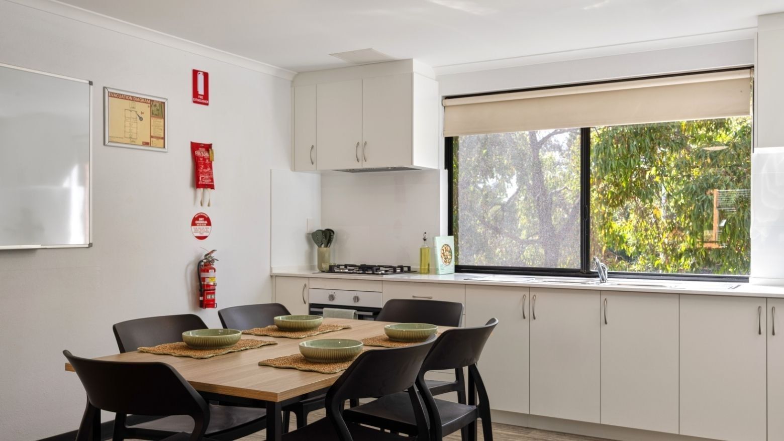 Spacious kitchen and dining area with large window at UniLodge at Curtin University - Erica Underwood House.