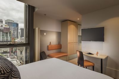 TV & king bed in studio Room at Brady Hotels Central Melbourne