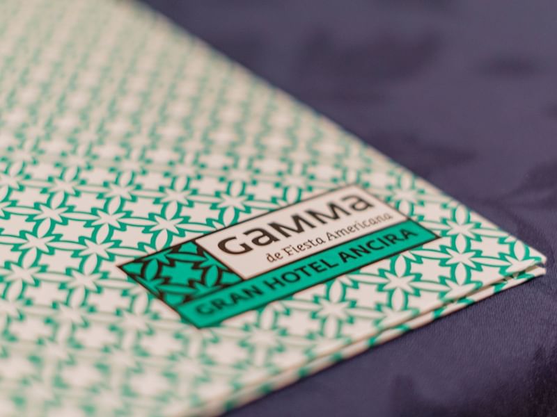 Close-up of a menu card on a table in Monterrey at Gamma Hotels