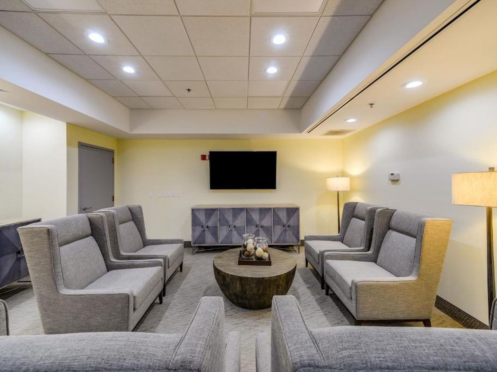 Cozy sofa set-up with TV in Executive Boardroom One at St. Louis Airport Hotel