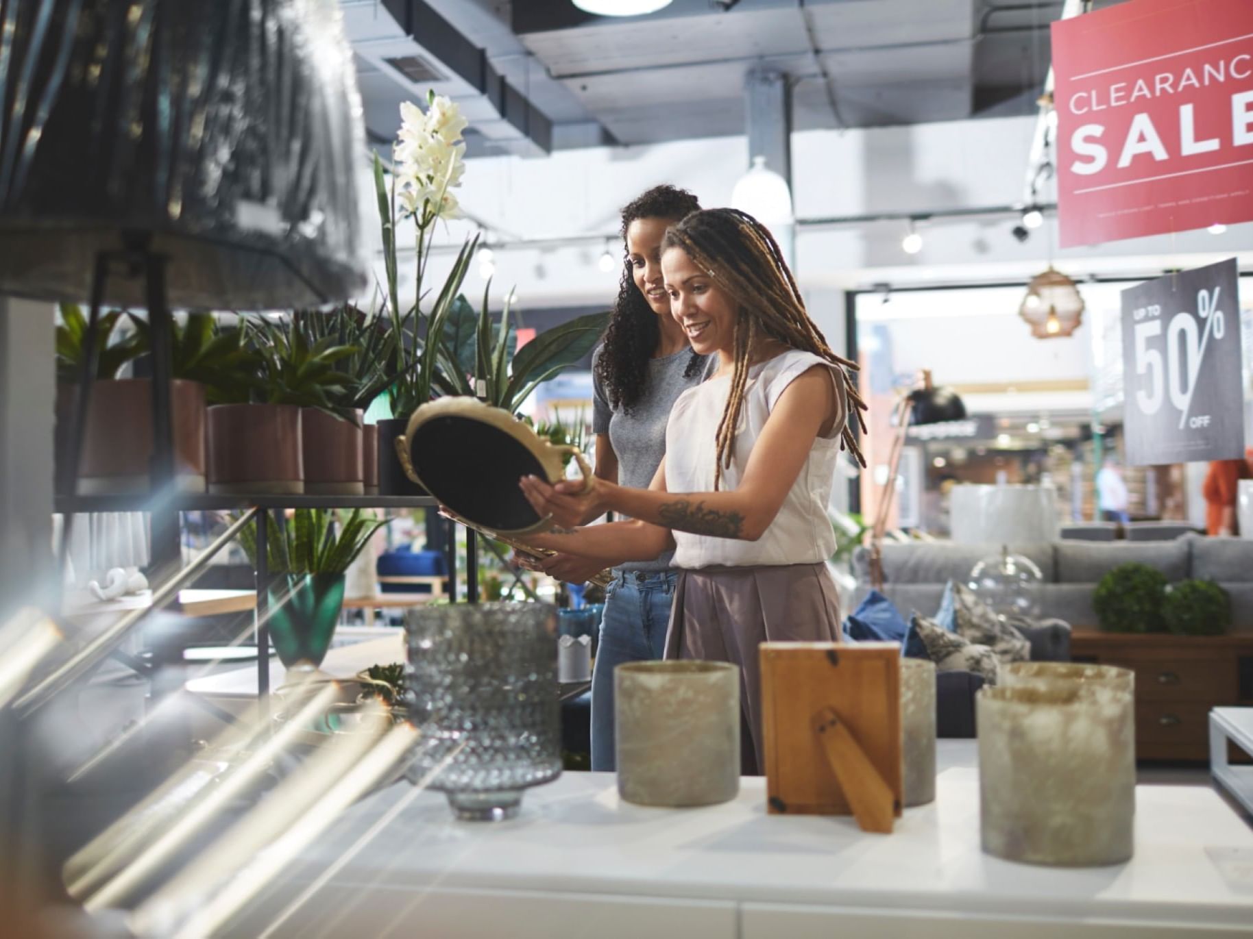 Two women admiring ornaments in a Boutique Store near Gorges Grant Hotel