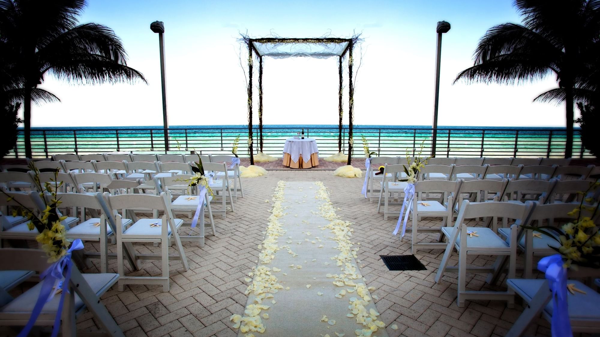 Wedding ceremony arrangement in South Palm Court Terrace at The Diplomat Resort