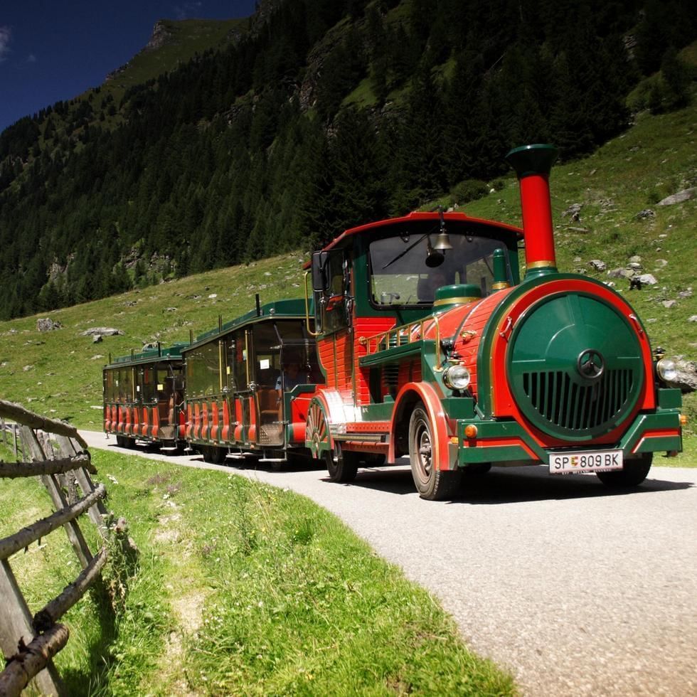 E choo choo train on a mountain road in Poellatal Nature Reserve near Falkensteiner Hotel Cristallo