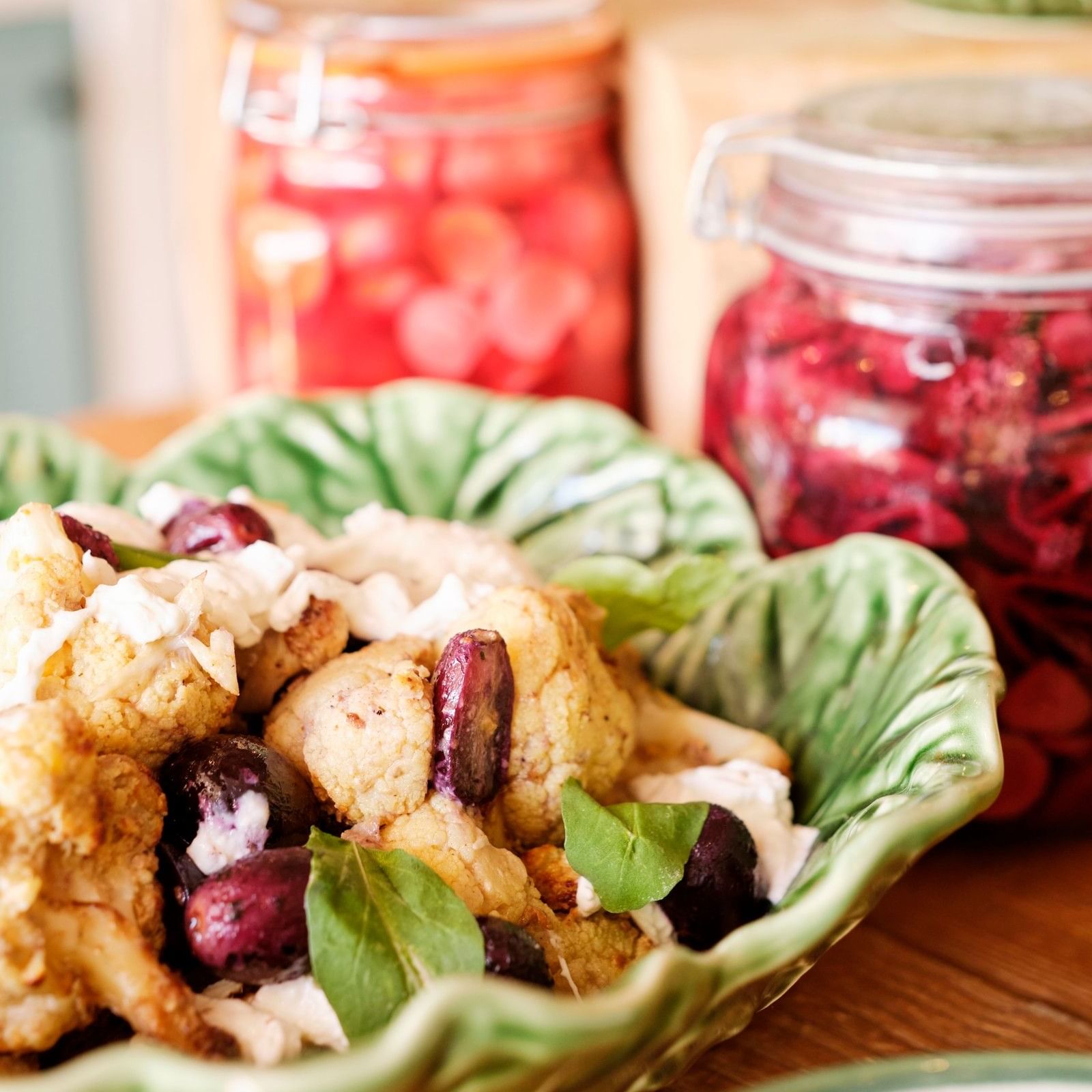 Vegetable salad with olives in a green bowl at El Olivar by Chef Andrés, Marbella Club in Marbella.