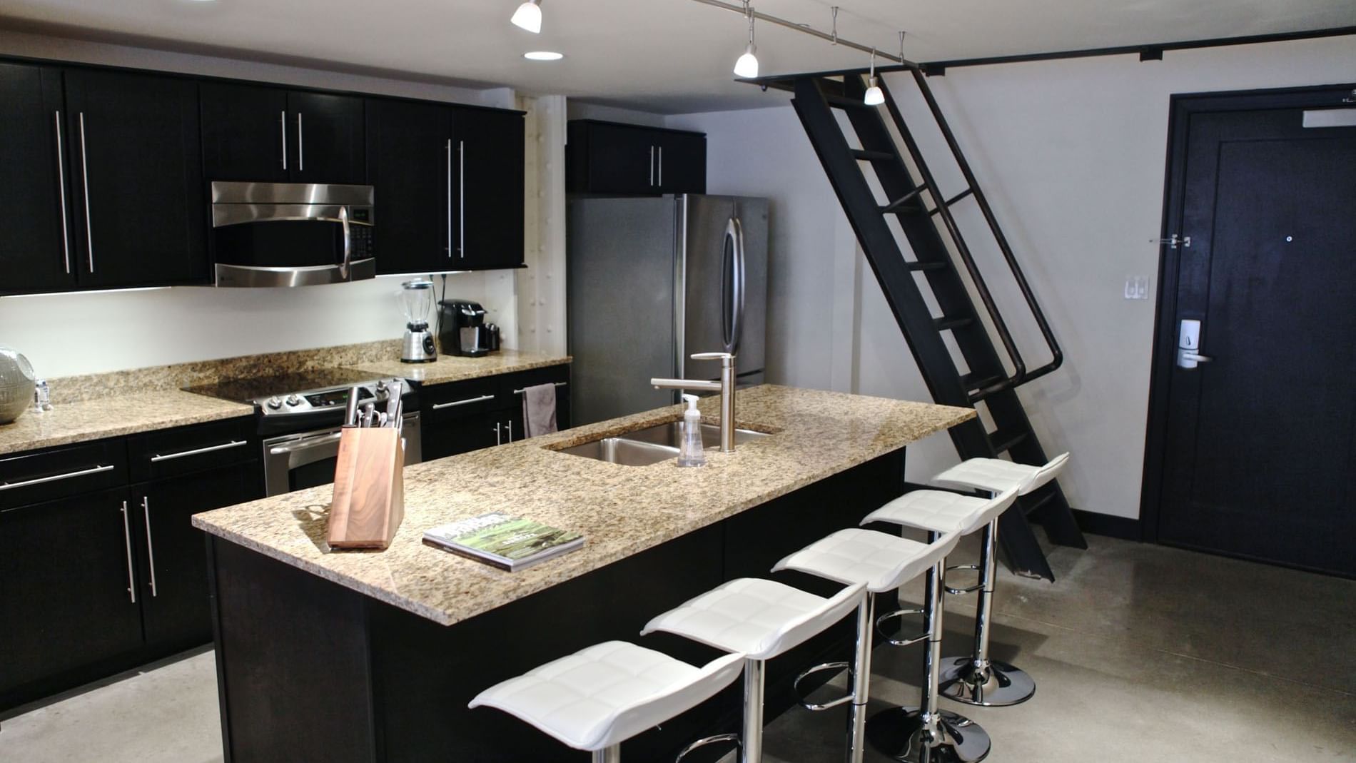 Kitchen with appliances in Unit N Terrace at The Mayo Hotel