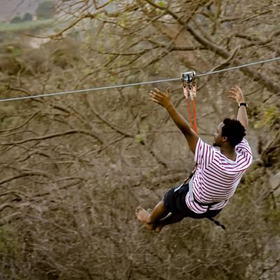 Man ziplining with free hands near Falkensteiner Hotels