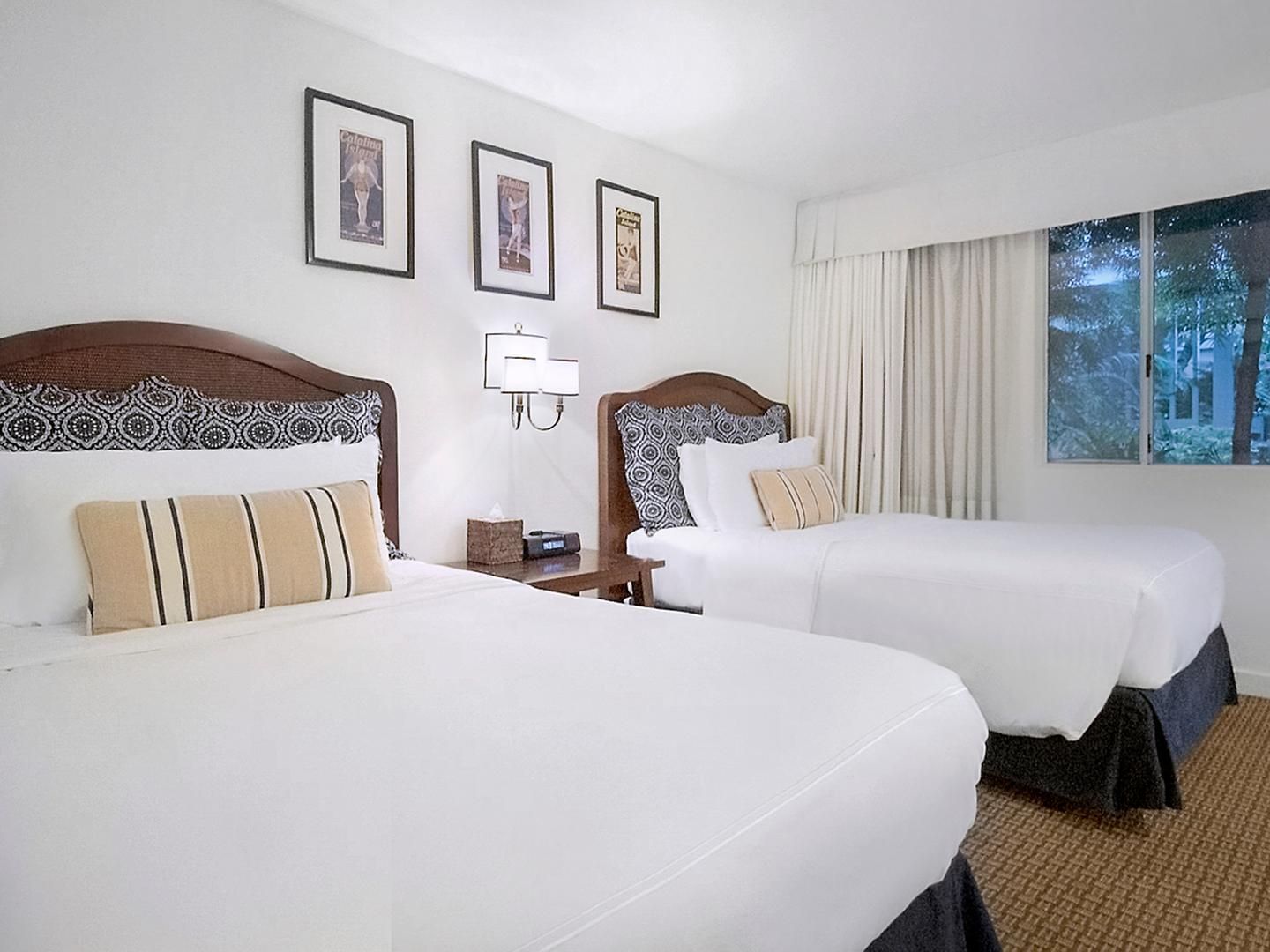 Two cozy beds with carpeted floors in Standard ADA Rooms 301 and 303 at Pavilion Hotel