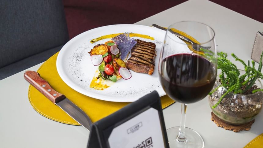 A meal served with wine at Grand Hotels Lux