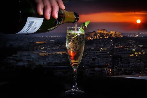 Closeup on champagne pouring by sunset at St George Lycabettus