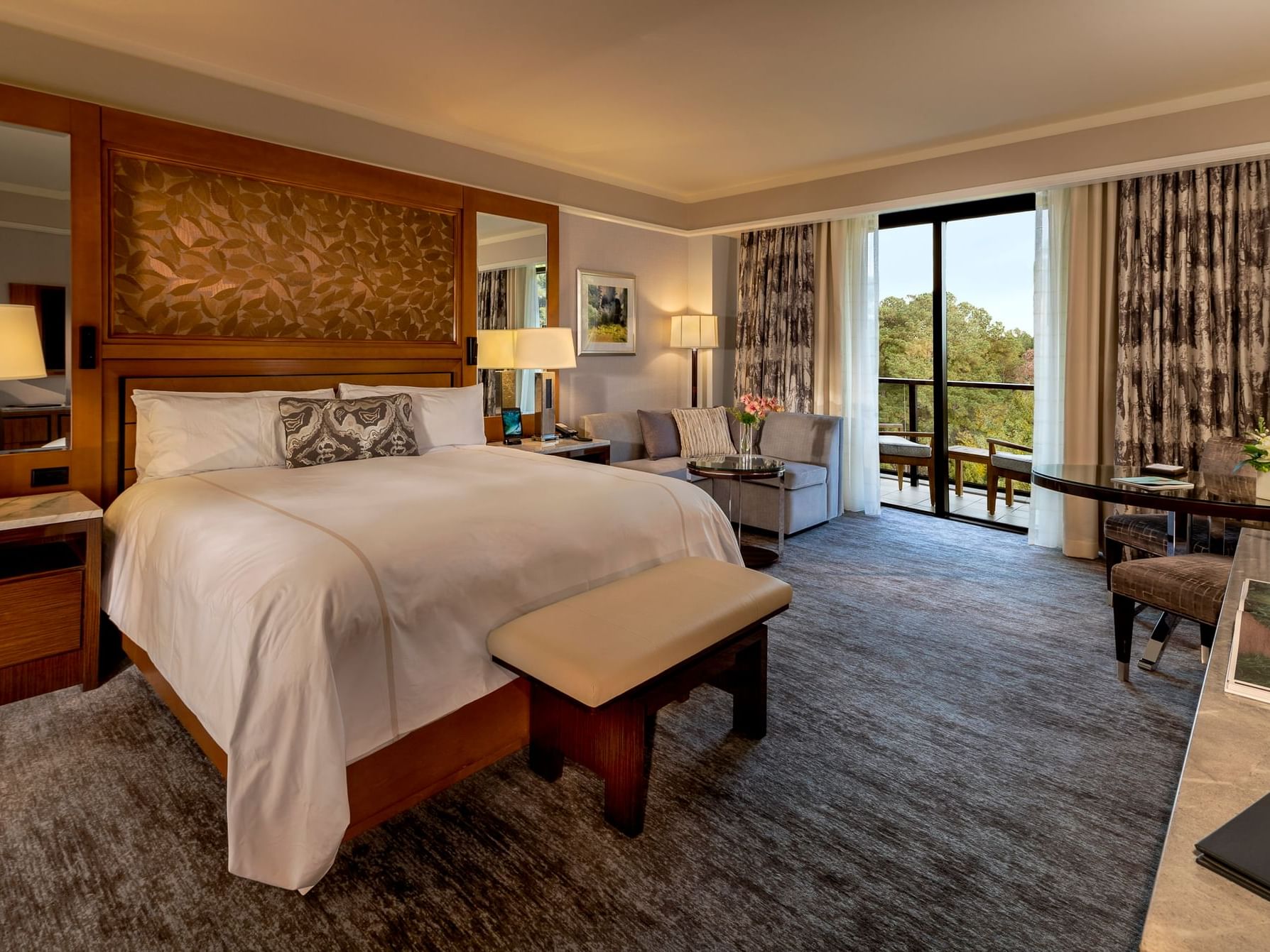 Comfy interior with carpeted floors in Lake View Balcony Room at The Umstead Hotel and Spa