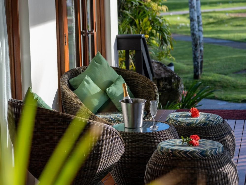 Woven armchairs surrounding a champagne bucket with wine and flowers at The Naviti Resort in Korolevu.