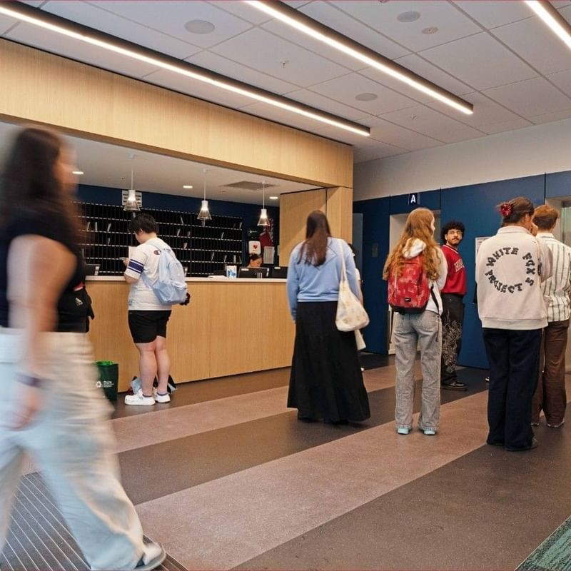 People at the front desk of Mayoral Drive Student Accommodation.