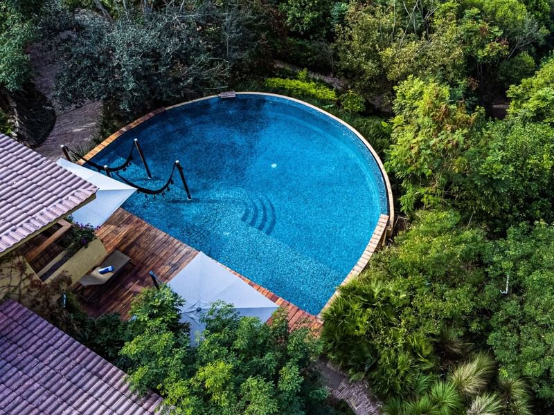 Aerial view of Gamma hotels with pool surrounded by trees at Gamma Hotels