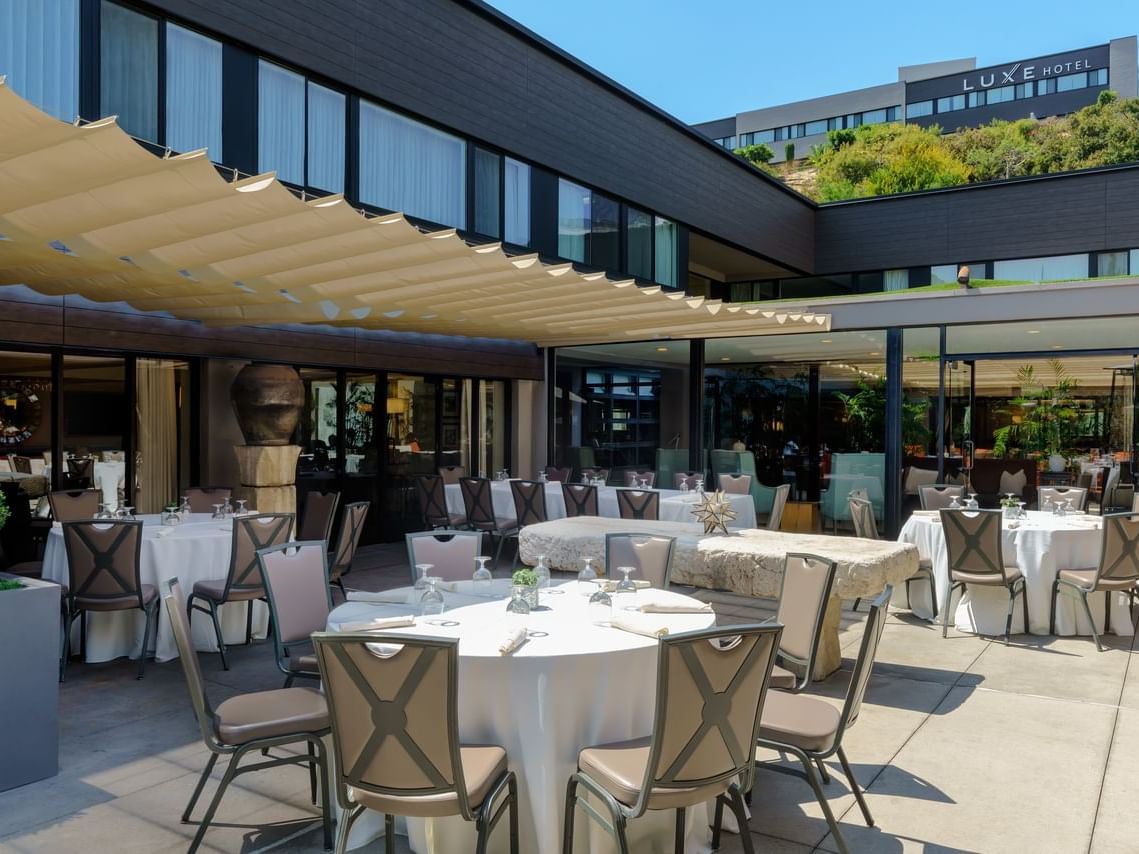 Tables , chairs set outside for dining at Luxe Sunset Boulevard