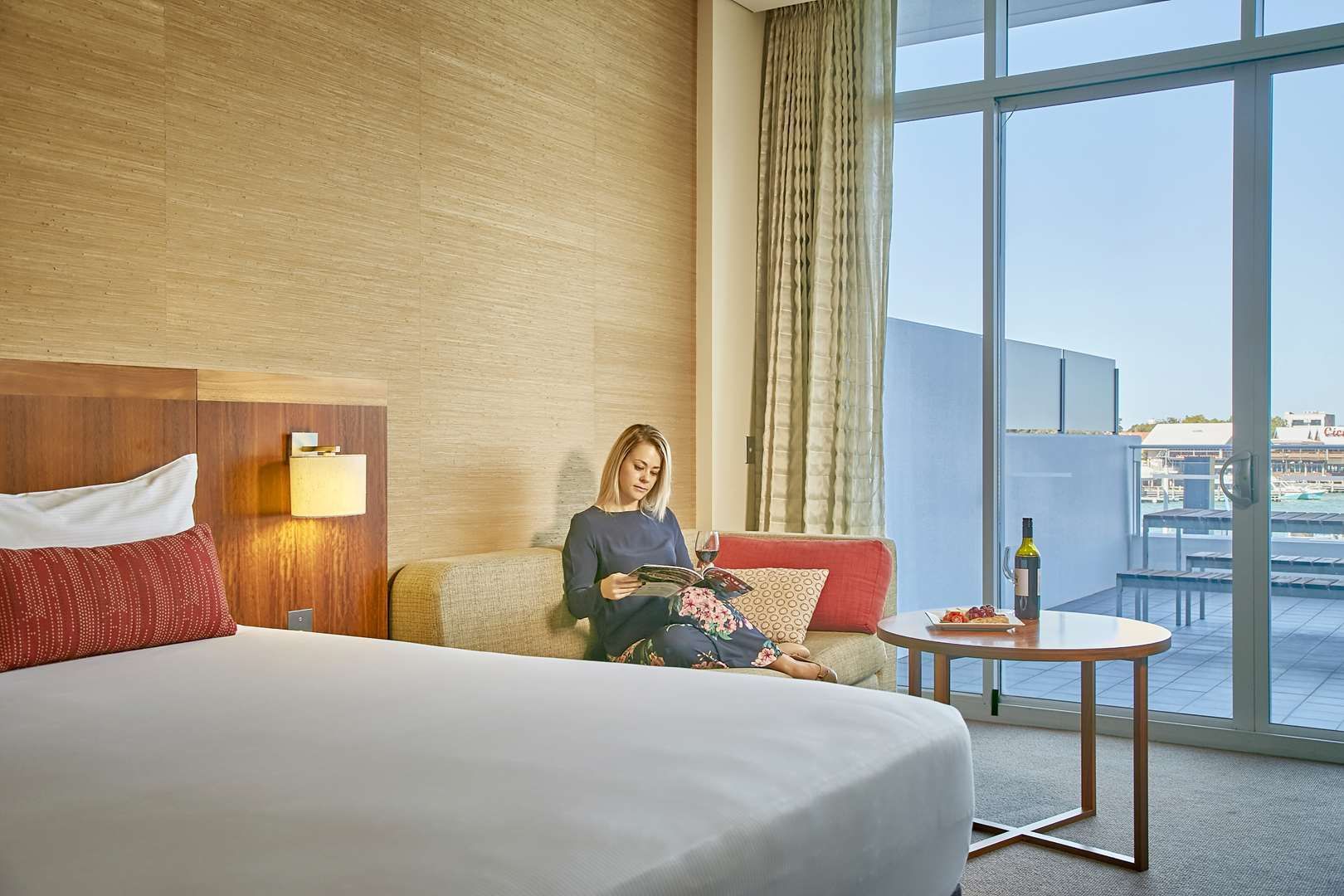 The Sebel Mandurah - A woman reading a book