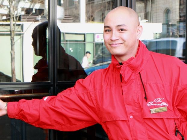 An employee at the entrance in Paramount Hotel Portland