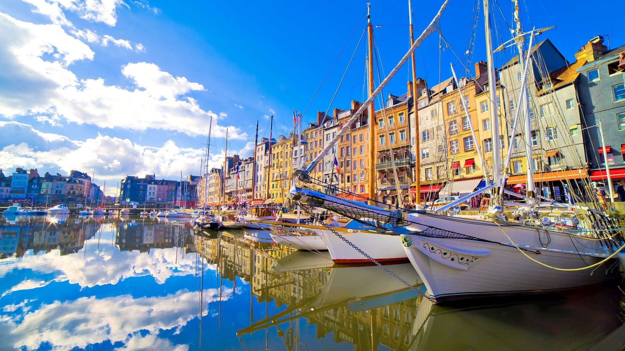 Boats stationed at Honfleur near The Originals Hotels