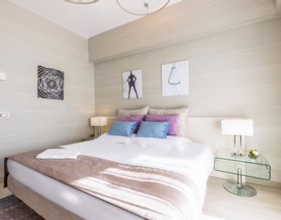 Bed and furniture in guest room at St. George Lycabettus