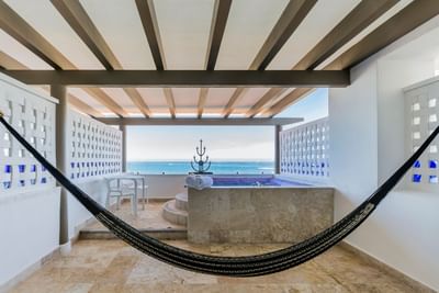A peaceful private balcony setup with a traditional hammock for ultimate guest relaxation.