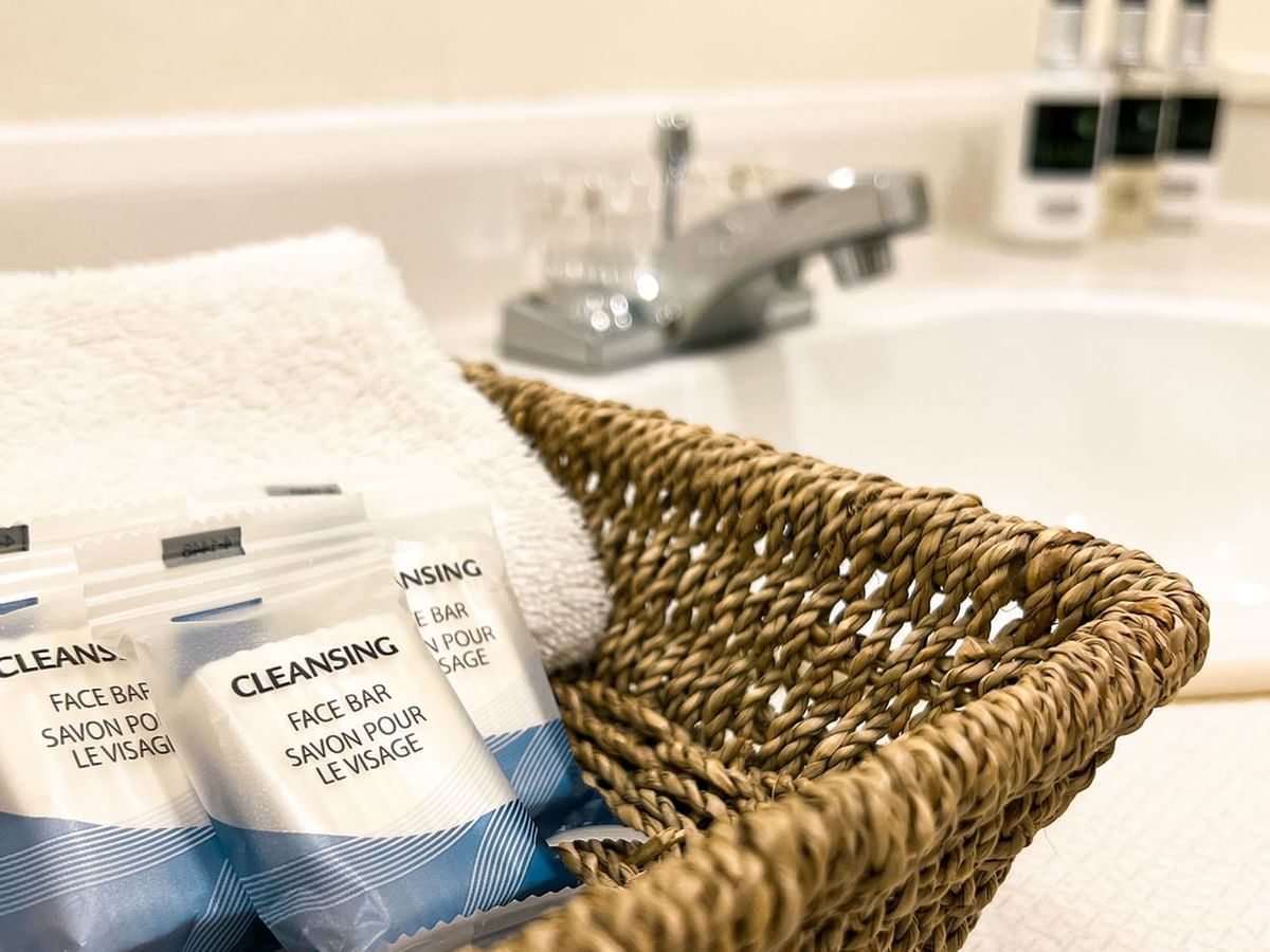 Basket of soap and towels, next to a bathroom sink
