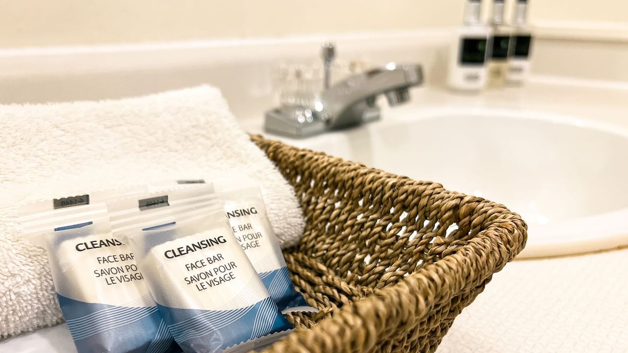 Basket of soap and towels, next to a bathroom sink