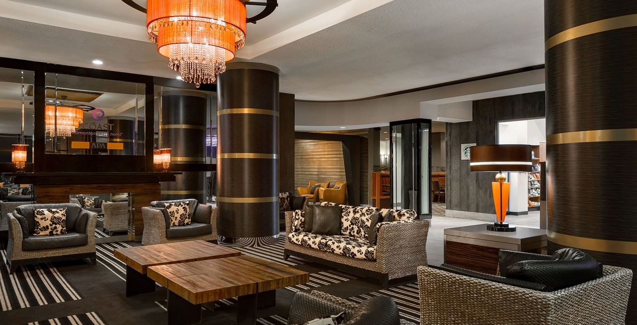 Hotel Lobby with couch, chandelier, tables, and mirrors