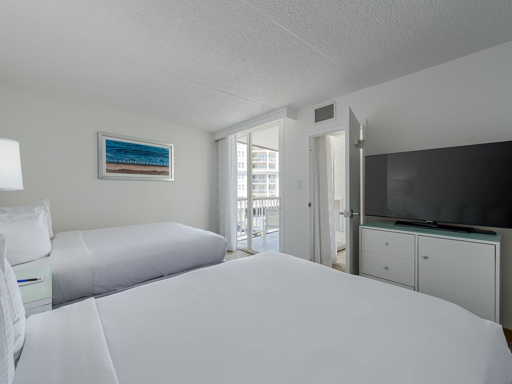 Tv & Twin beds in Signature Suite at ICONA Diamond Beach Resort