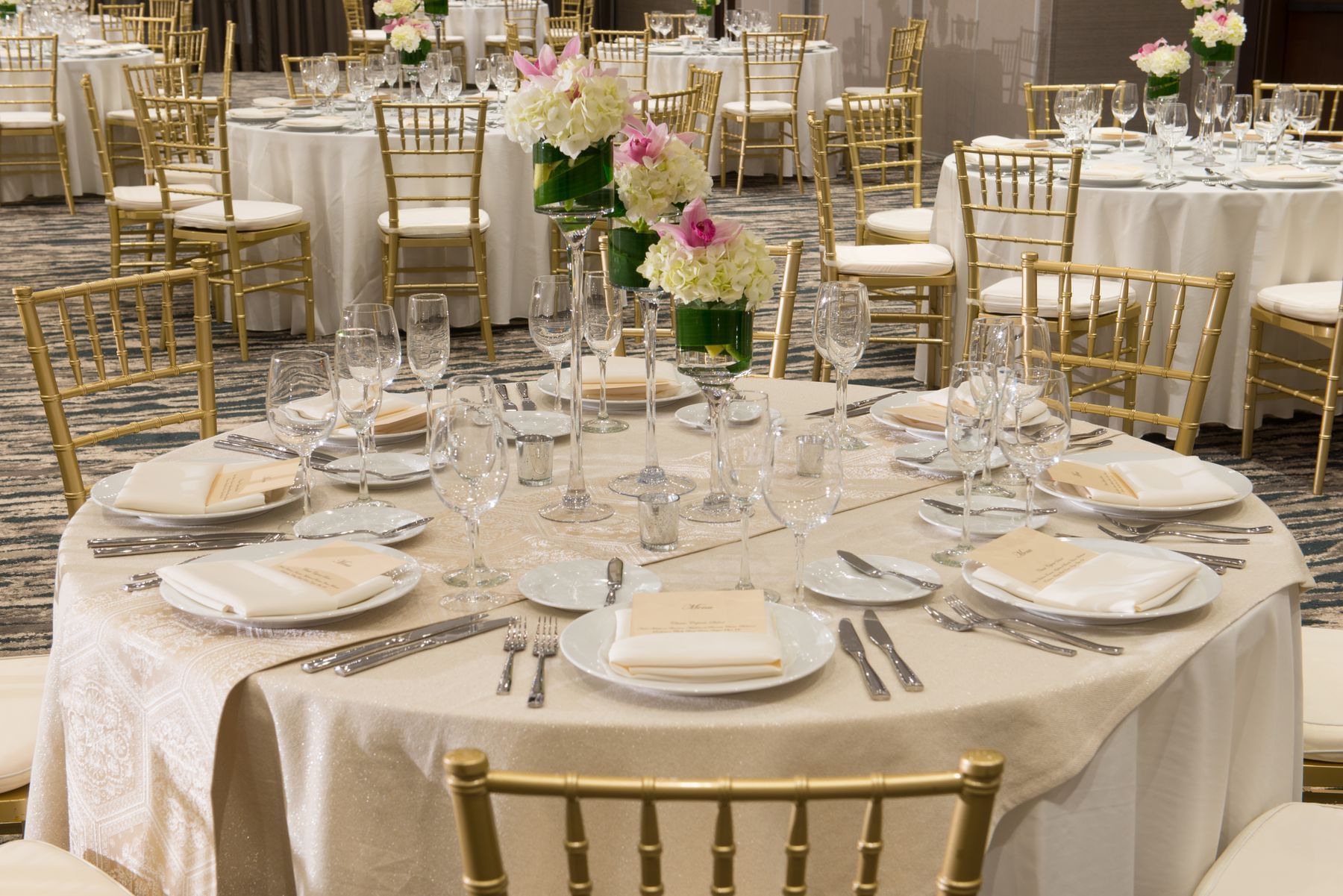 Banquet rounds set with floral centerpieces 