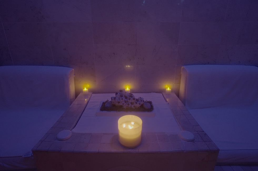 Serene spa setting with candles, two lounge chairs at Live Aqua Resorts and Residence Club