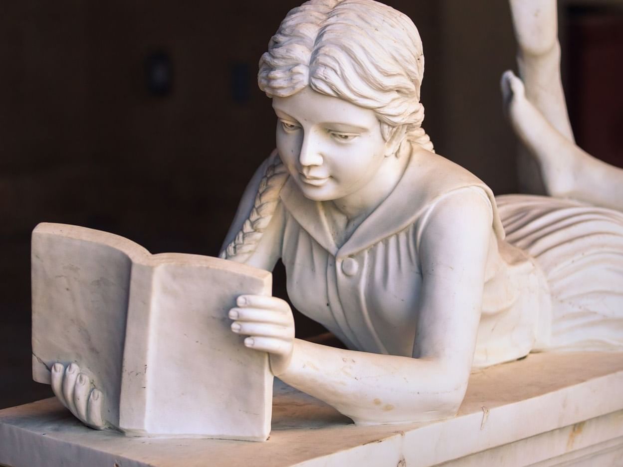 Sculpture of girl reading book