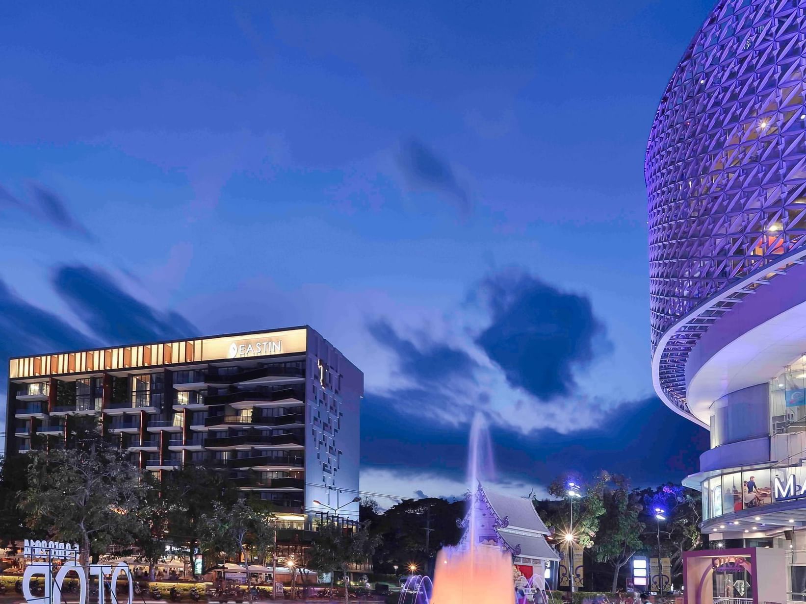 Exterior distance view of Eastin Tan Hotel Chiang Mai & fountain at night