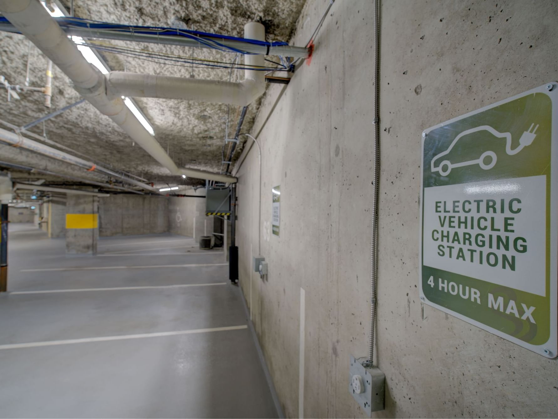 Underground parking with an electric vehicle charging station at Blackcomb Springs Suites